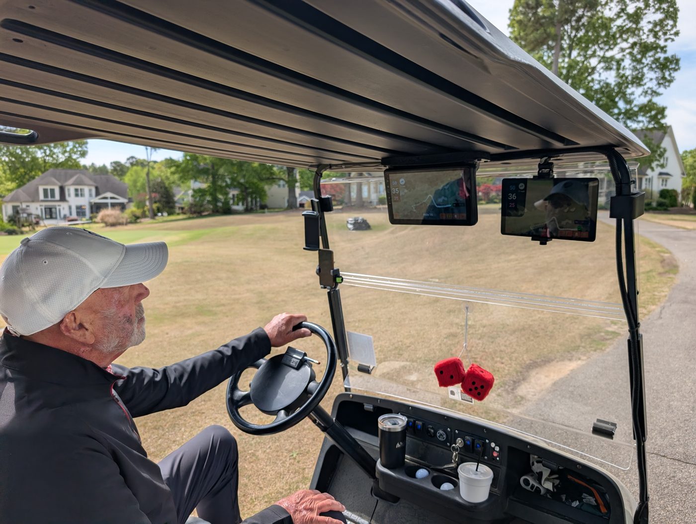 Golfer driving with two Aimy screens visible